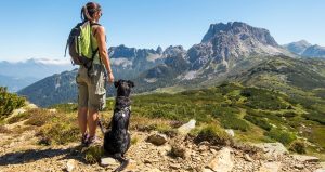 Woman hiking with a dog