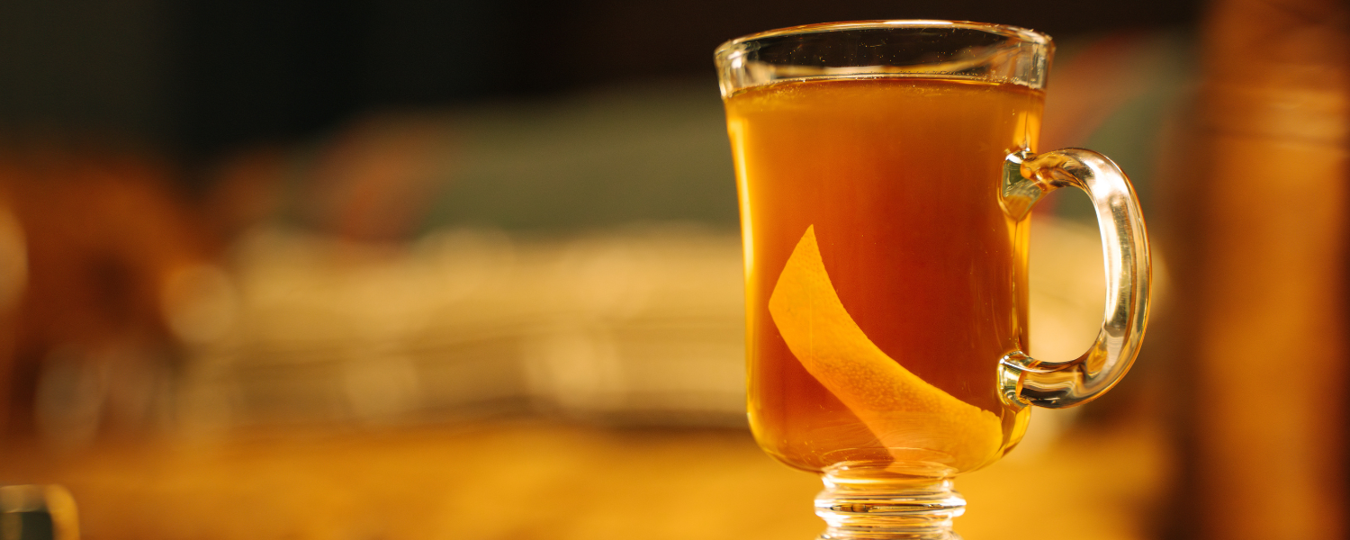 amber beverage with orange peel